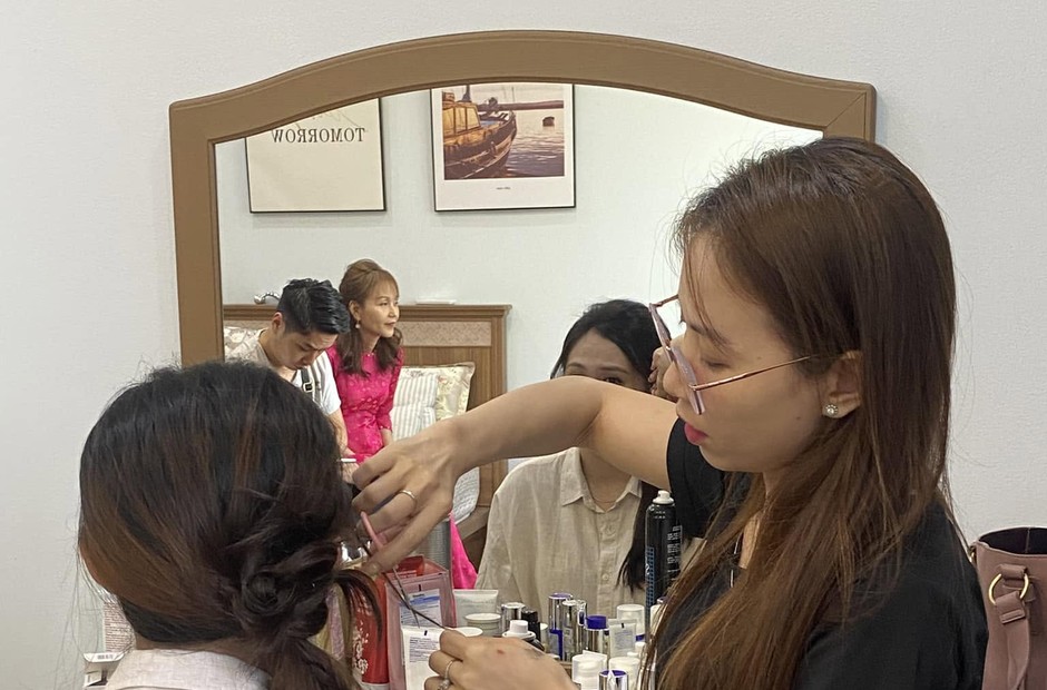 Thợ tạo kiểu tóc cho khách tại studio Kiều Min